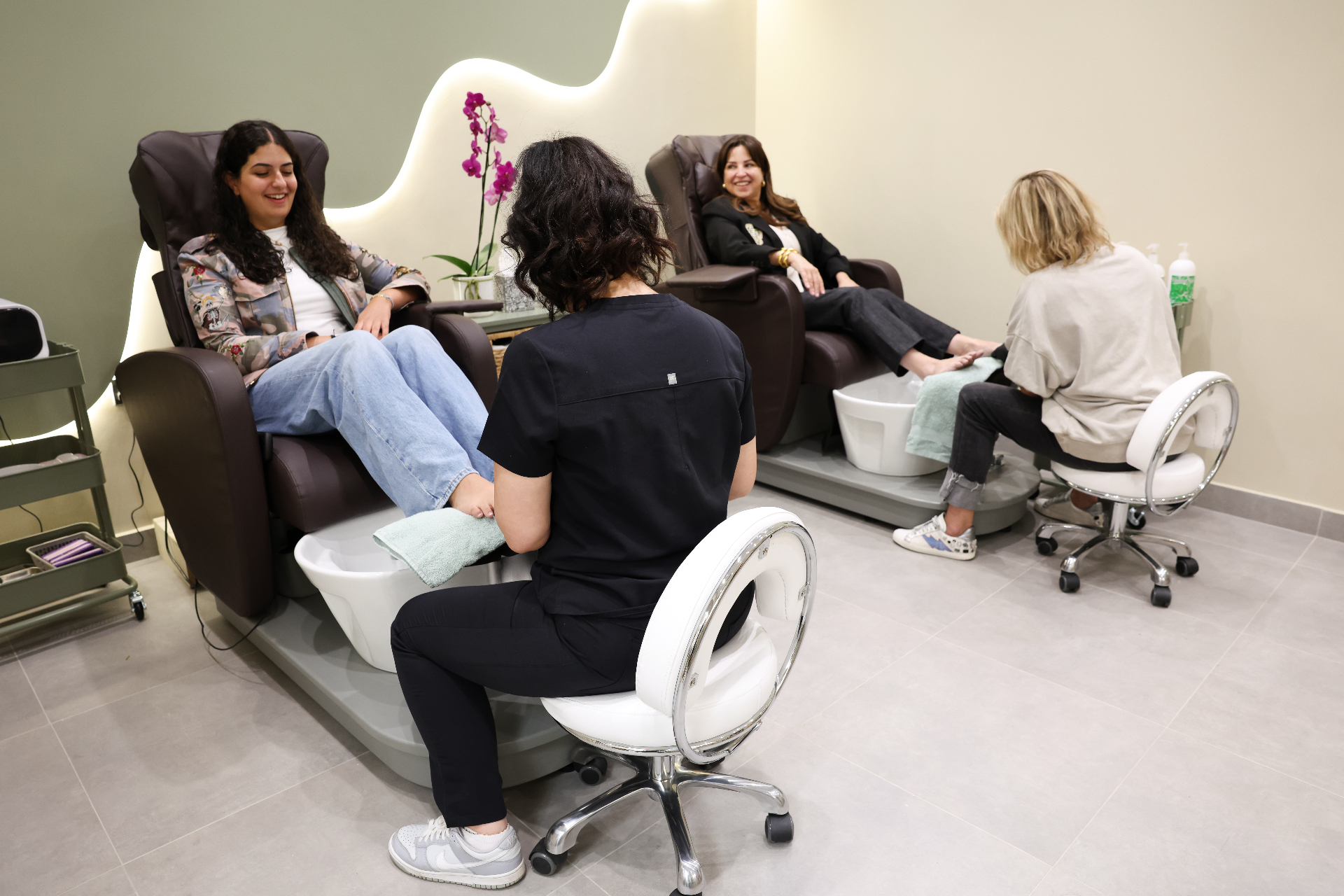 Guests relaxing during pedicure treatments at Marnis Salon
